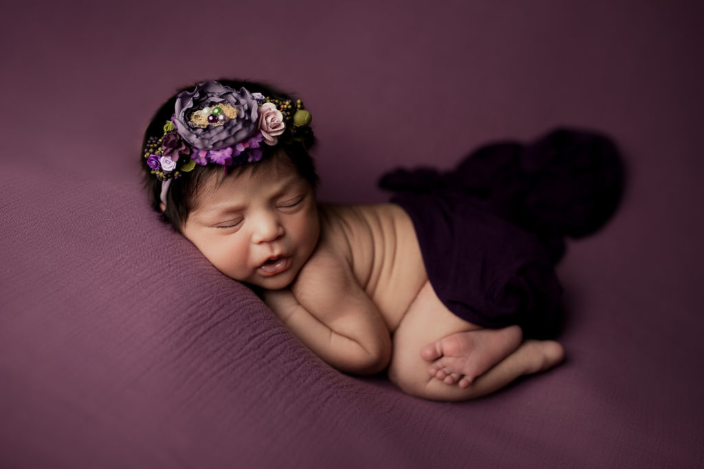 baby girl in purple during her newborn photography session with savannah Williamson Photography
