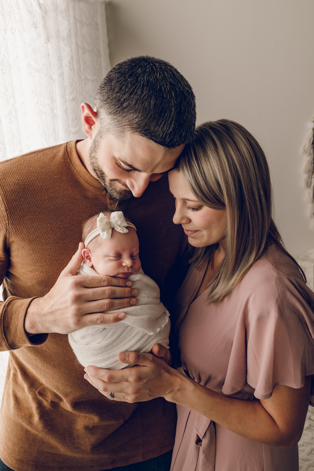 Beautiful family photo with mom dad and newborn baby. Helps clients see example of my photography sessions.