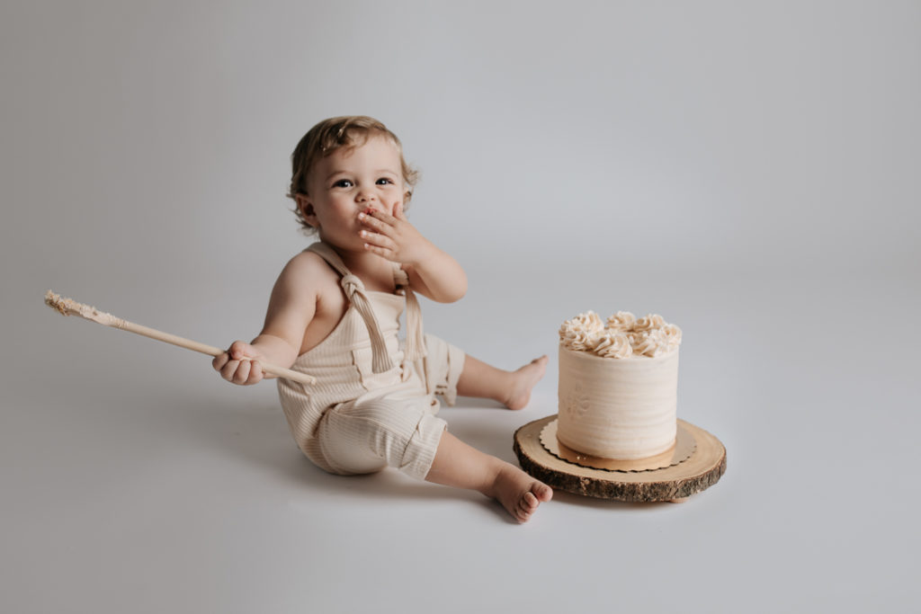 baby eating a cake during a cake smash session