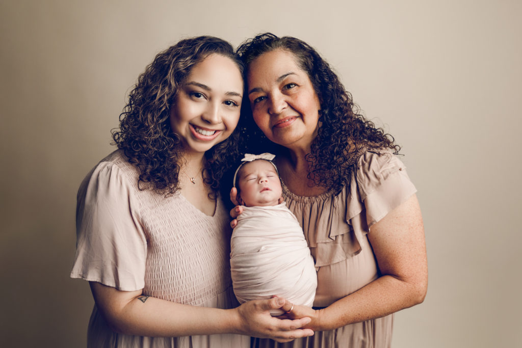 Photo of a newborn baby girl with her mother and grandmother in a studio newborn photography session in Tucson Arizona