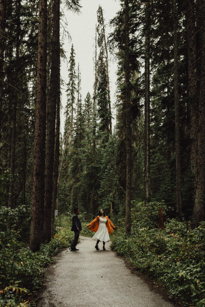 This couple is dancing in the forest to celebrate their Banff elopement.